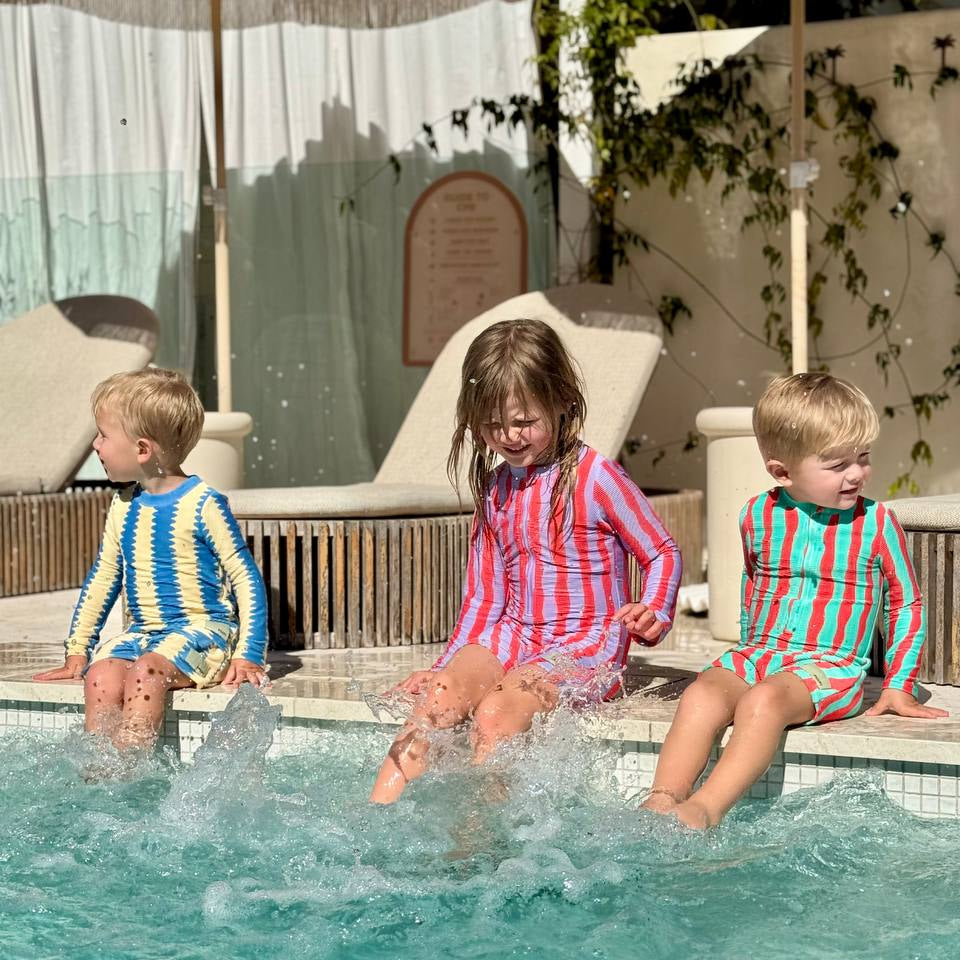 Kids jumping into pool wearing Pekpi Sea Kelp Shorties