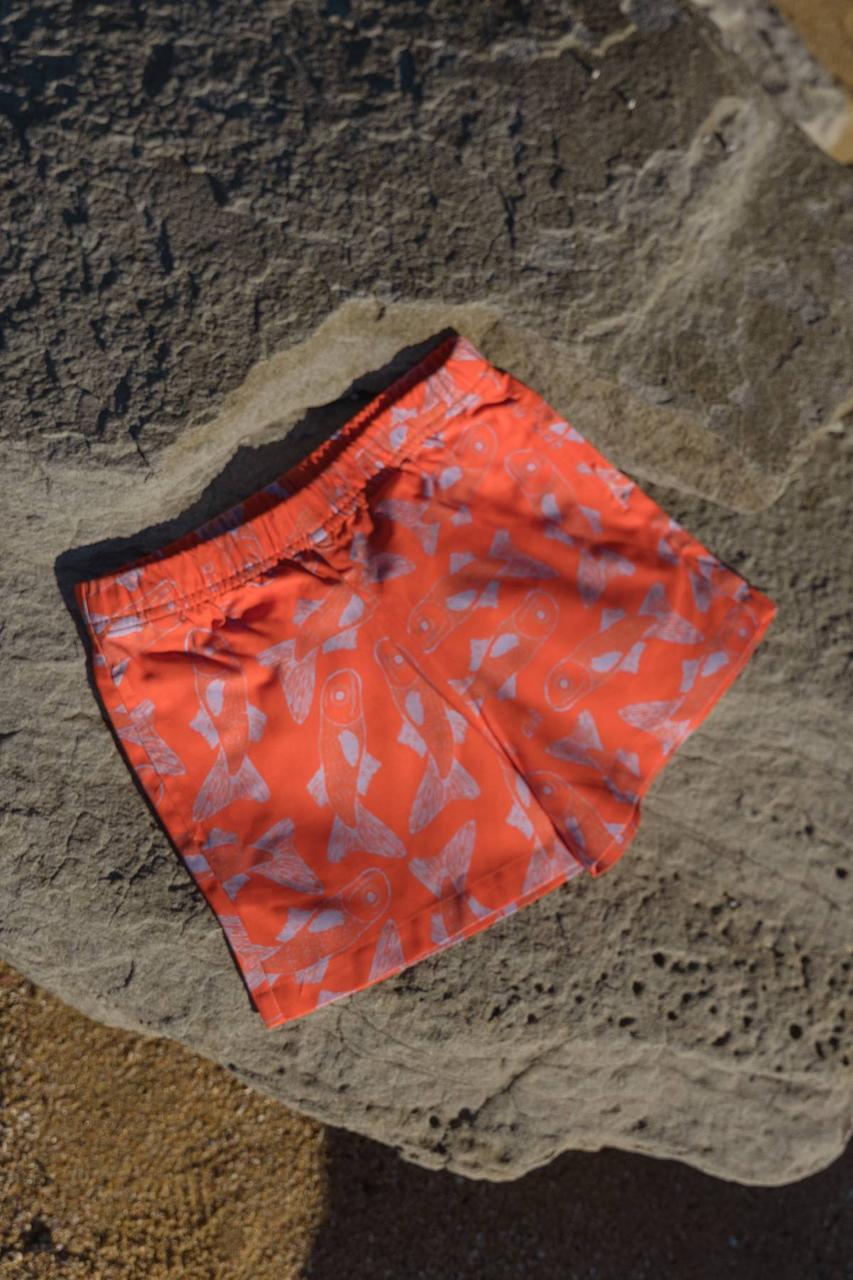 Big Glub Shorts - flat lay on beach rocks front view