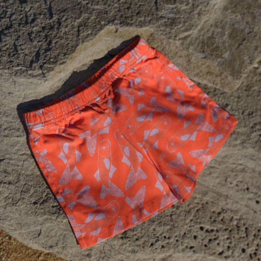 Big Glub Shorts - flat lay on beach rocks front view