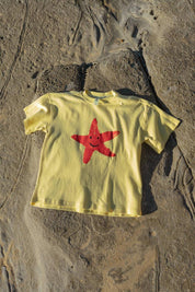 Starfish Tee Yellow - flat lay front view on rocks