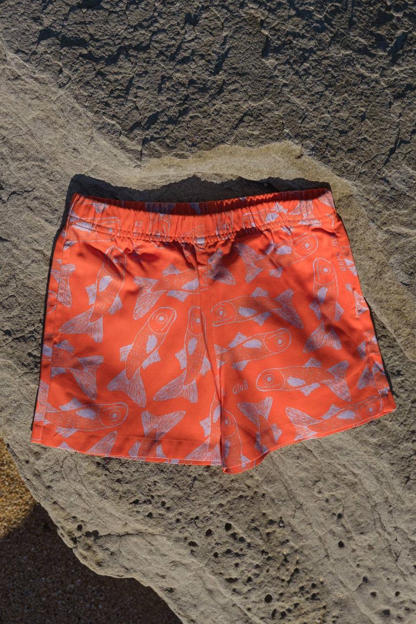 Big Glub Shorts - flat lay on beach rocks back view