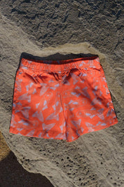 Big Glub Shorts - flat lay on beach rocks back view