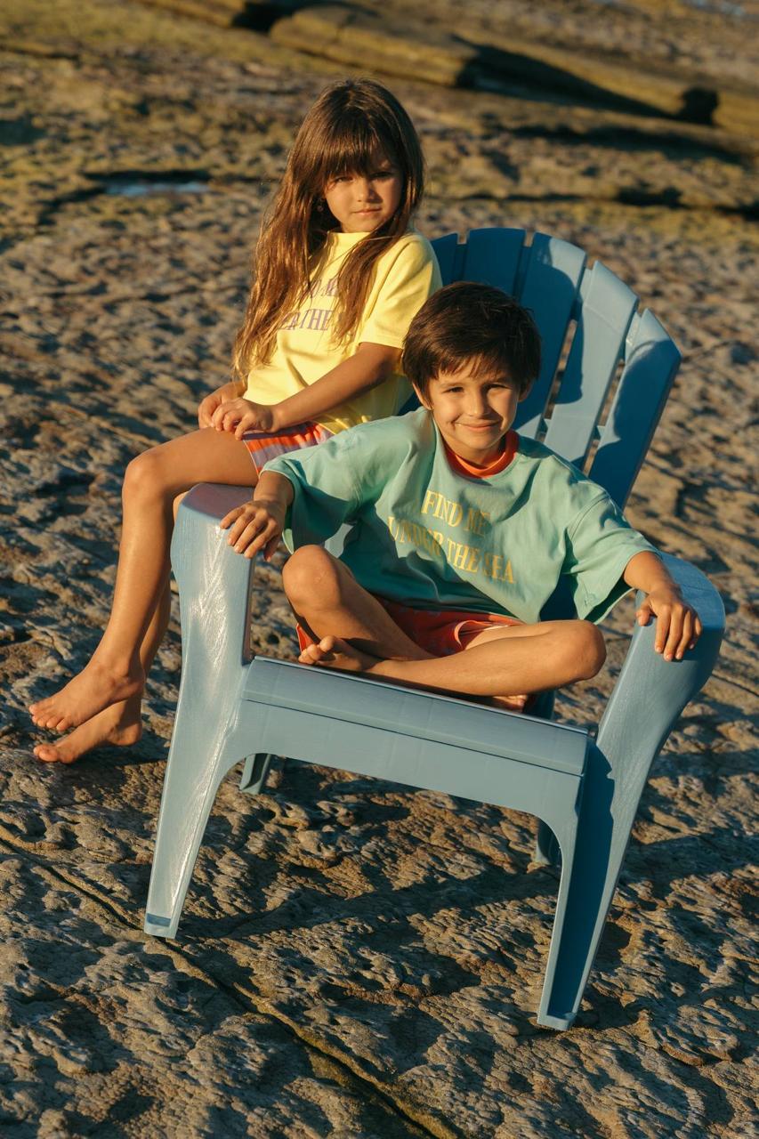 Sea Tee Green - kids on beach chair golden hour