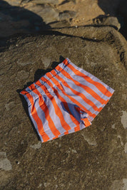 Pipi Shorts - flat lay on beach rocks front view