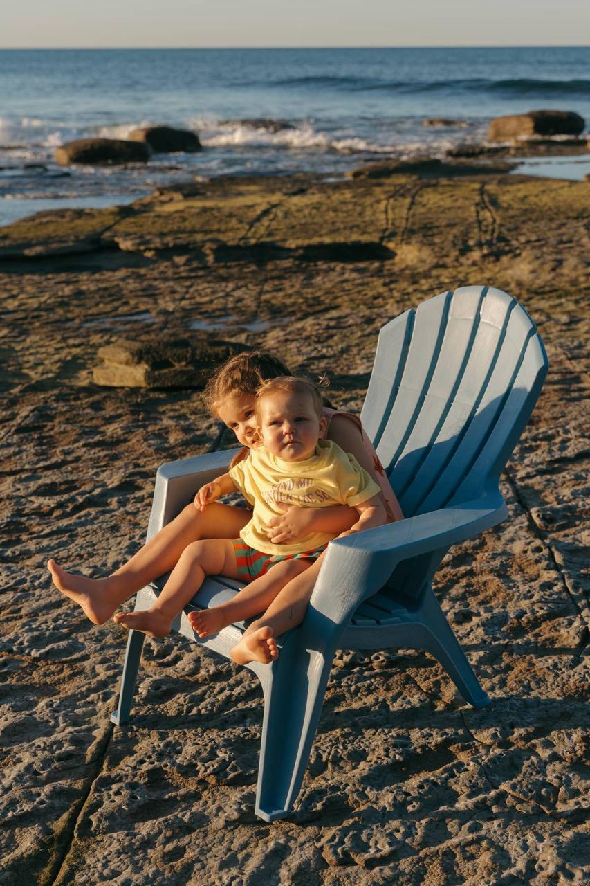 Pipi Shorts - siblings on beach chair golden hour