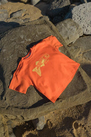 Big Glub Tee - flat lay on beach rocks