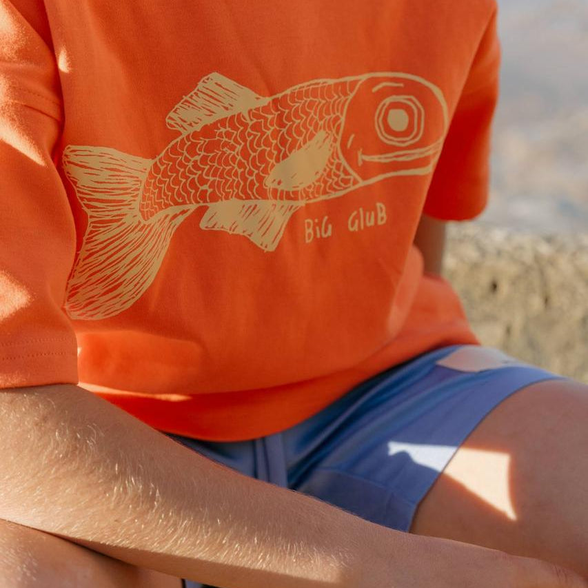 Big Glub Tee - close up fish print on orange tee