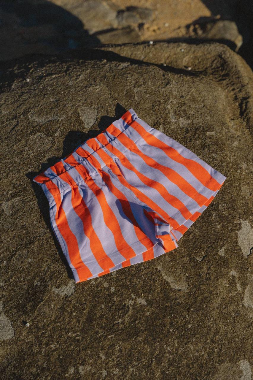 Pipi Shorts - flat lay on beach rocks