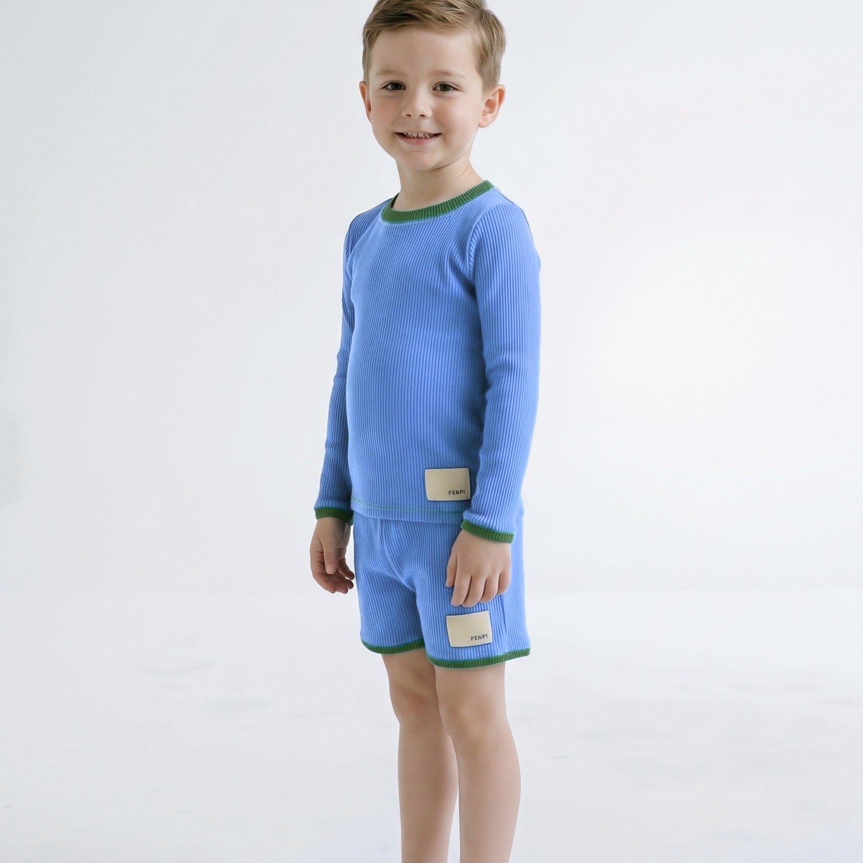 Boys rashie and swim shorts in Bold Blueberry on model