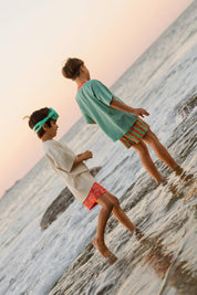 Big Glub Shorts - boys playing in ocean waves at sunset