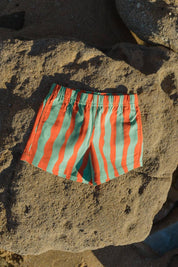 Aqua Shorts - flat lay on beach rocks front view