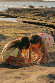 Pipi Shorts - kids exploring rock pools at sunset