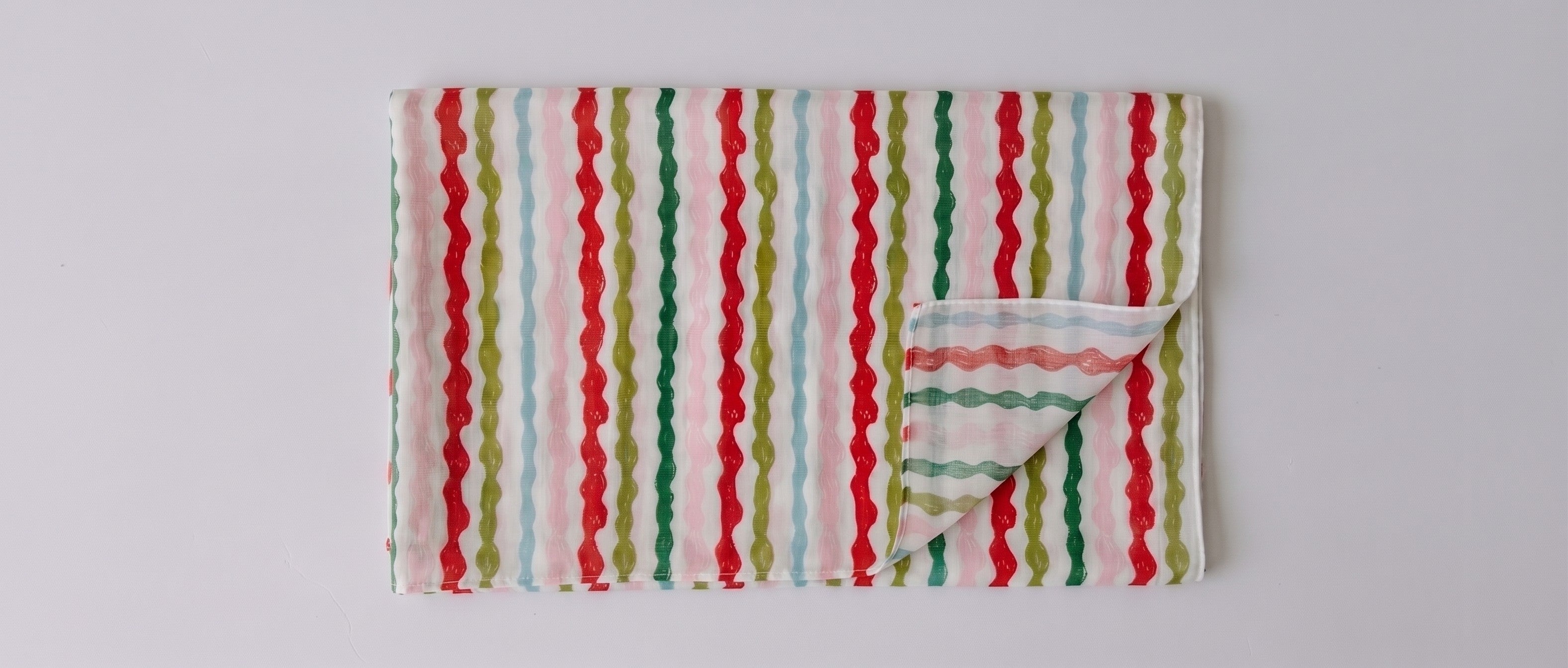 Womens voile sarong in Popsicle Wobble Stripe, folded (AI-generated image matched to our print)