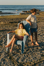 Pipi Shorts - girl in beach chair styled with Sea Tee Crop Yellow