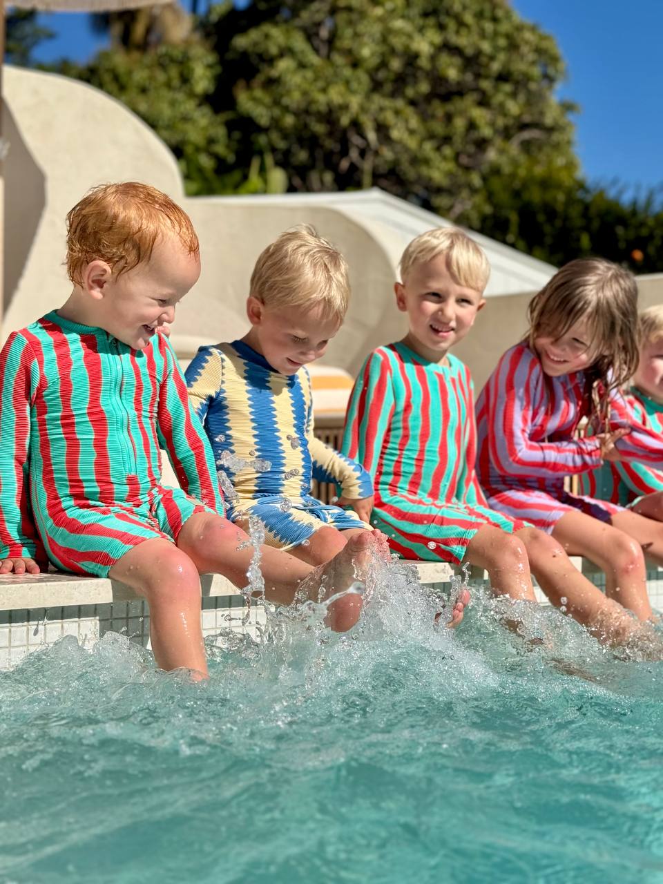 Kids splashing at pool wearing Pekpi shorties