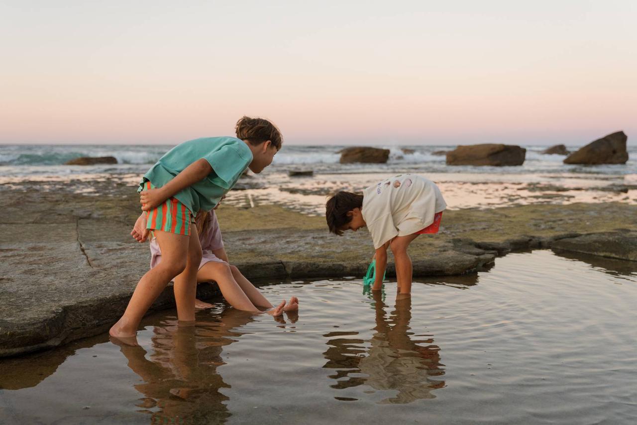 Aqua Shorts - kids playing in rock pools at sunset
