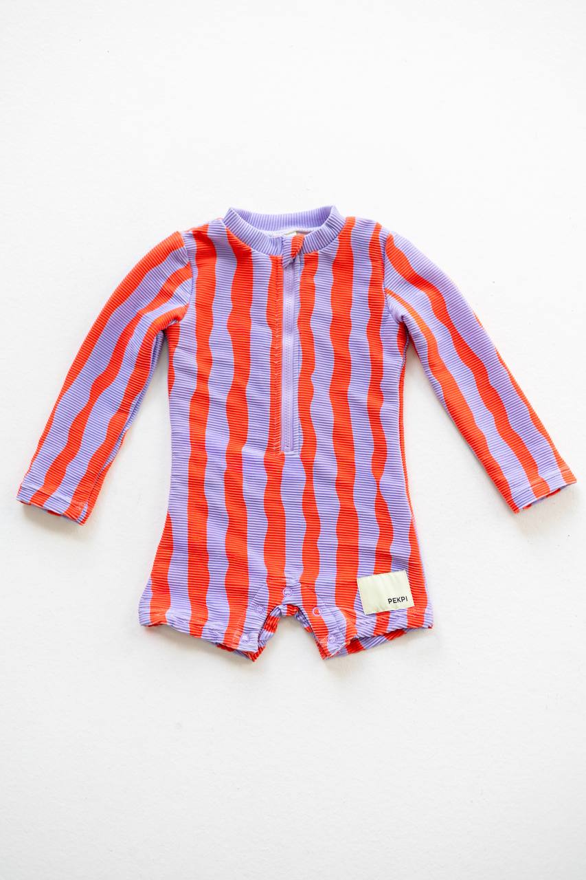 Sea Kelp Pipi Shortie flat lay front view showing snaps and Pekpi label