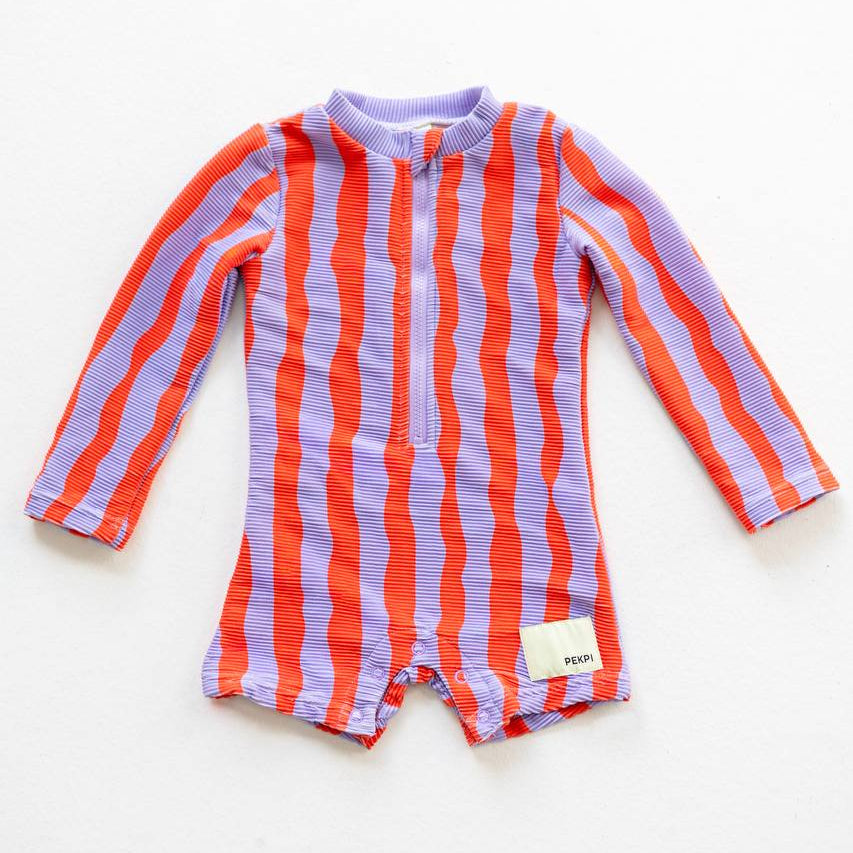 Sea Kelp Pipi Shortie flat lay front view showing snaps and Pekpi label