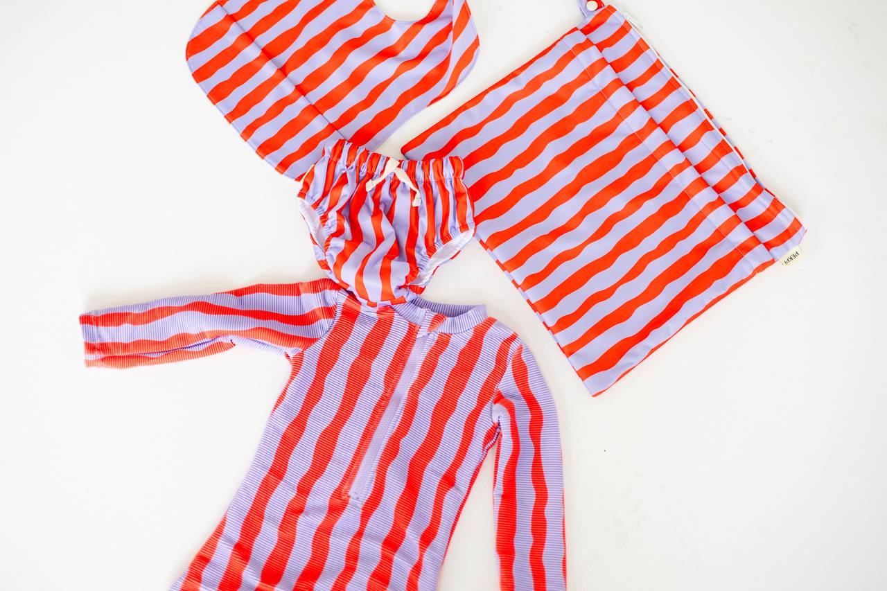 Sea Kelp Pipi Shortie flat lay with swim nappy, bib and wet bag