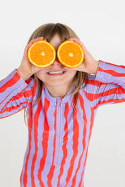 Girl holding orange slices over eyes wearing Sea Kelp Pipi Shortie