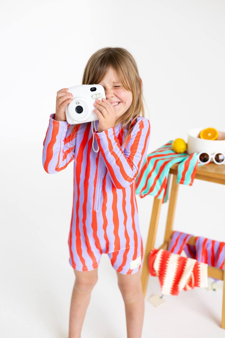 Girl with Polaroid camera wearing Sea Kelp Pipi Shortie