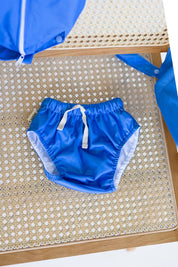 Rockpool Swim Nappy on rattan table with wet bag