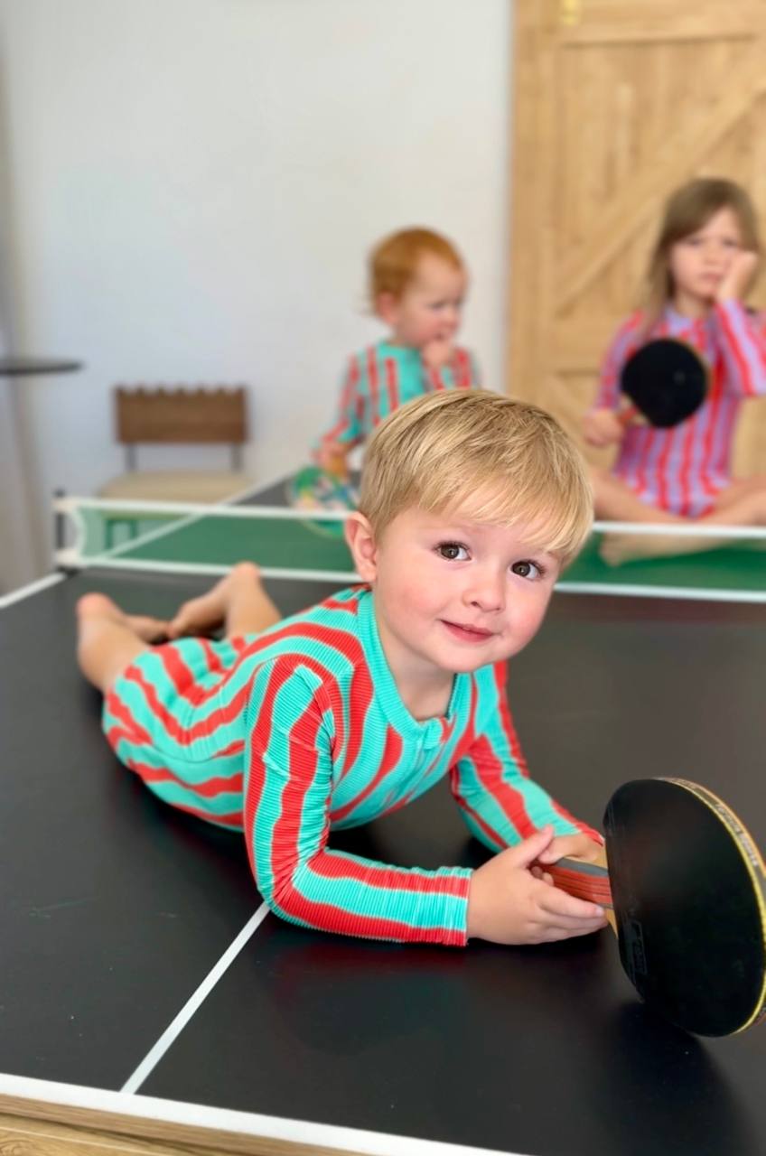 Kids playing ping pong wearing Sea Kelp Aqua Shortie