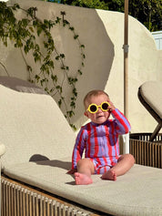Baby wearing Sea Kelp Pipi Shortie with yellow sunglasses poolside