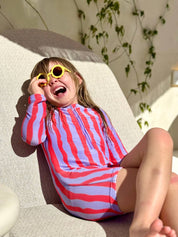 Girl laughing wearing Sea Kelp Pipi Shortie with yellow sunglasses